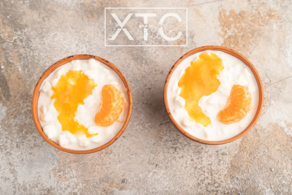 xtc tobcco orange cream tobacco flavor
two glass full of cream and orange on a table